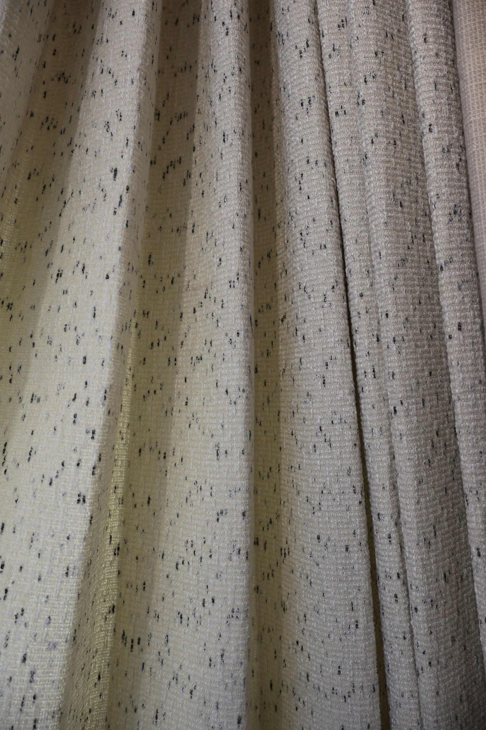 Neutral speckled curtain fabric detail