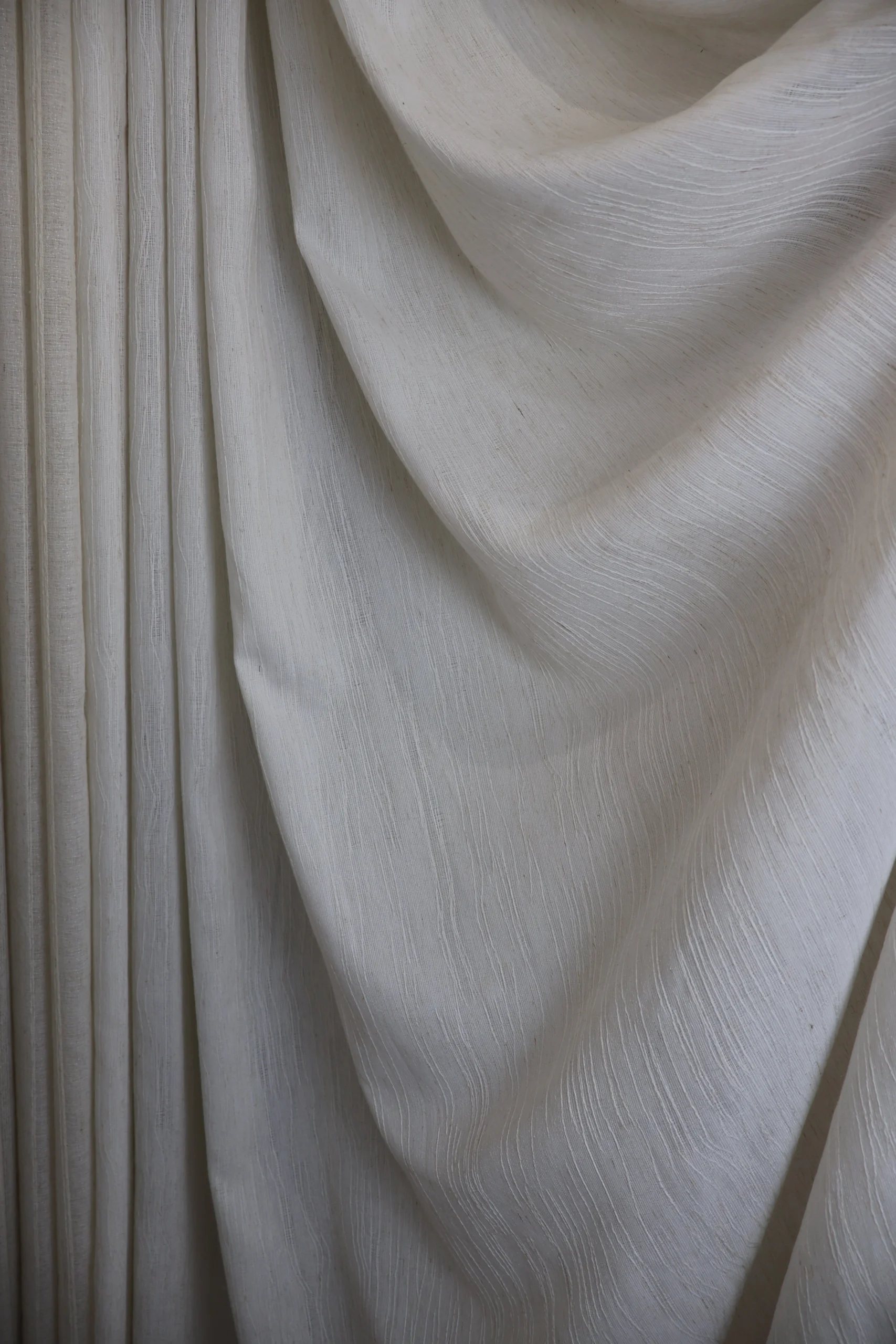 Ivory curtain fabric with a flowing drape