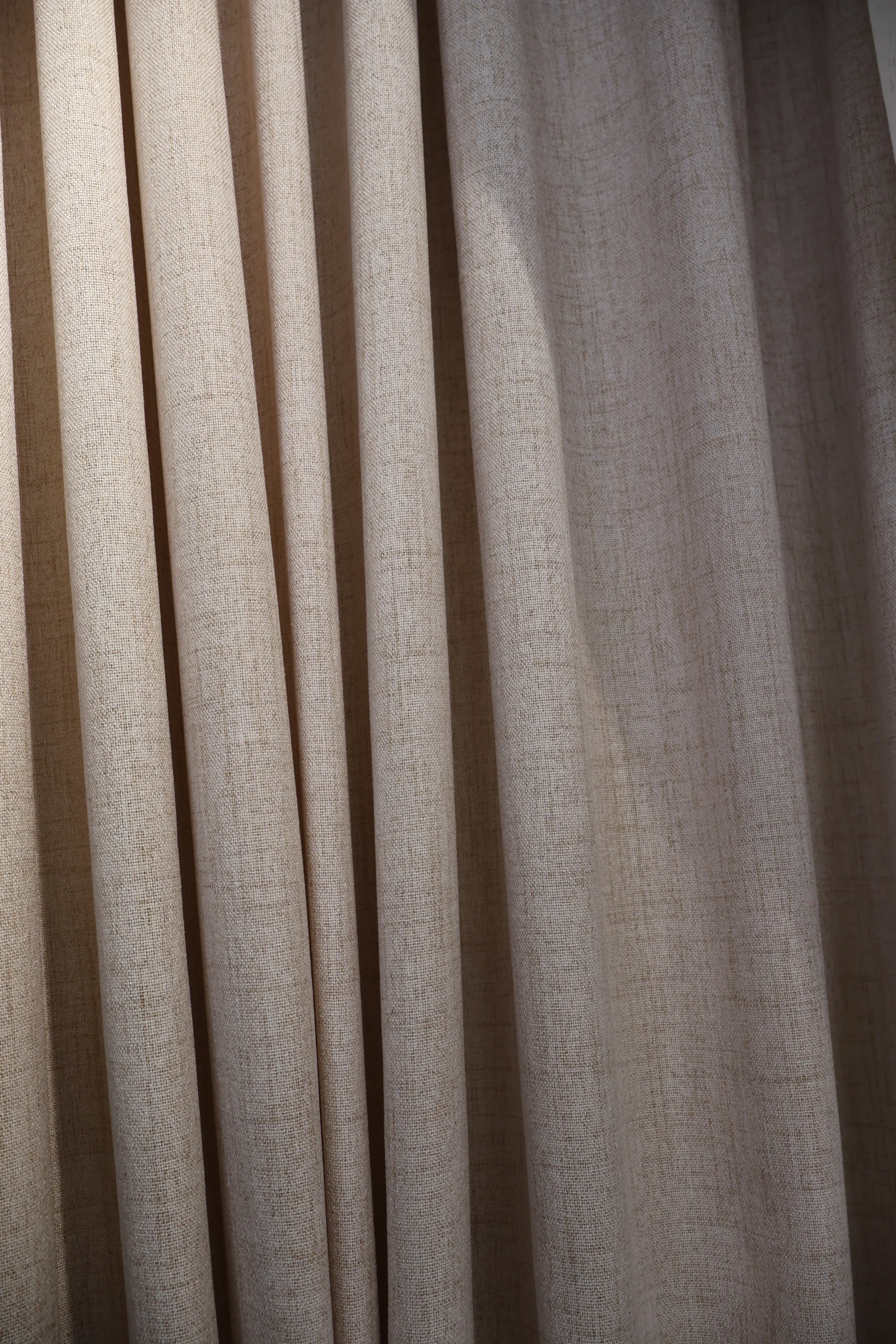 Warm taupe fabric with vertical folds