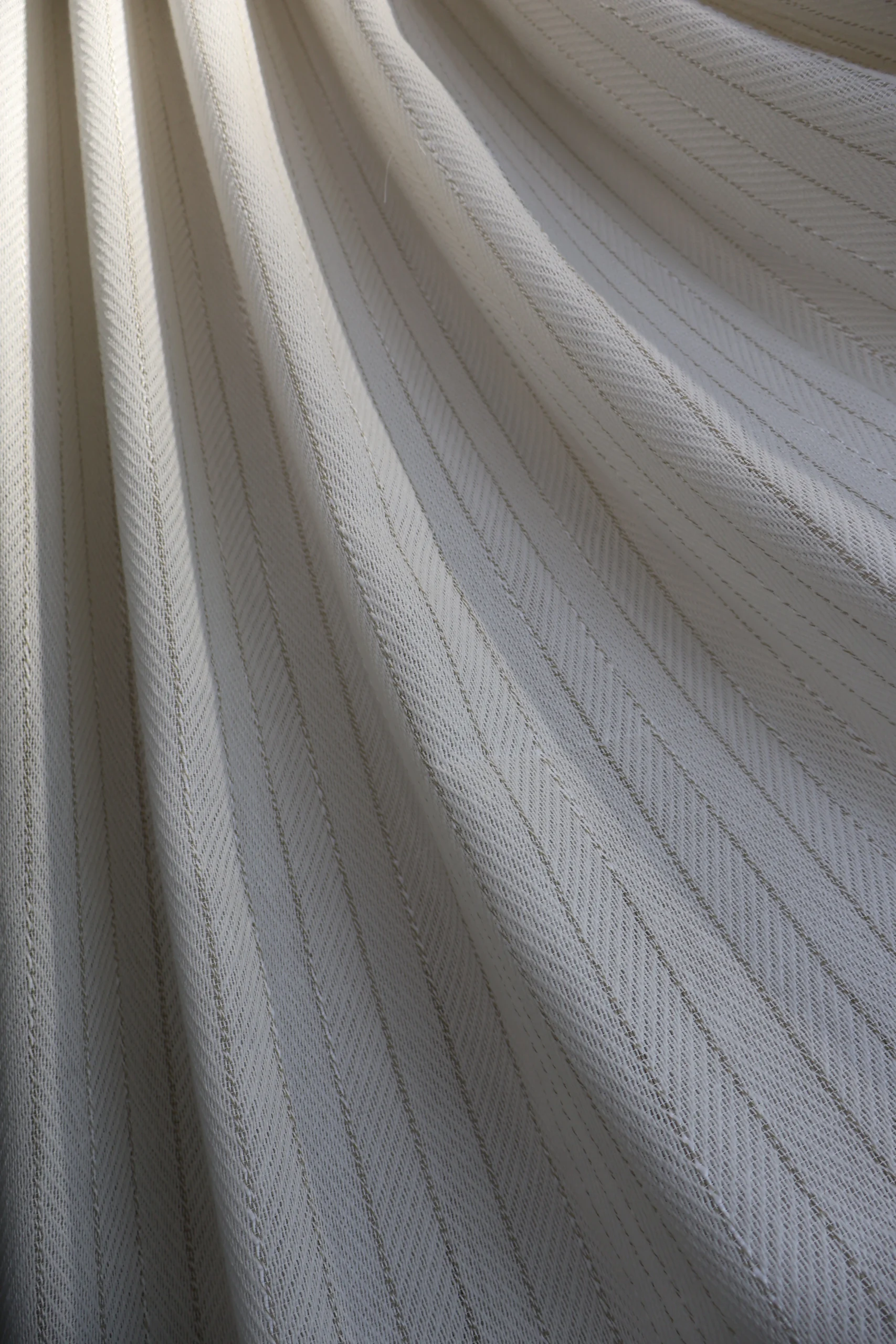 Pale curtain fabric arranged in soft folds